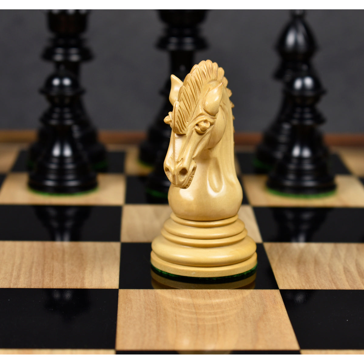Front view of a finely detailed boxwood knight piece from the Dragon Luxury Staunton chess set.