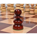 A single bud rosewood Pawn from the St. George Pre-Staunton Calvert chess set on a glossy chess board.