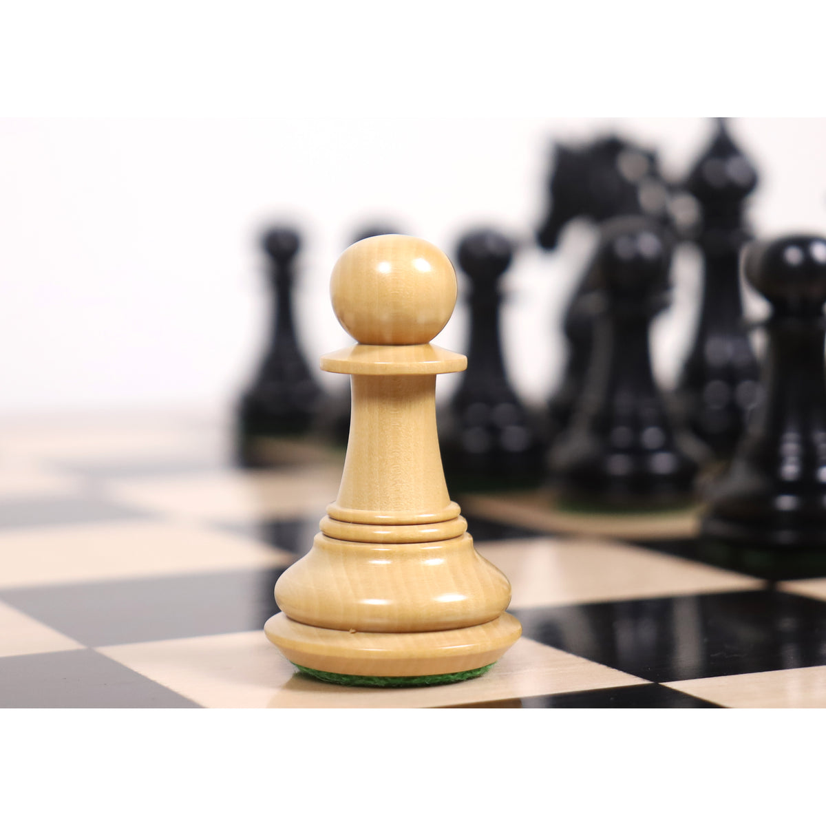Natural boxwood Spartacus luxury Staunton pawn featured on a chessboard.