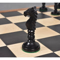 Profile of a black Minaret series hand-carved camel bone knight piece on a checkered chess board.