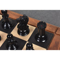 Black ebony Harrwitz Staunton knight and rook with red kingside stamping on a wooden chess board.
