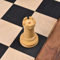 Close-up of a carved boxwood pawn from the Lessing Staunton collection on a chessboard.