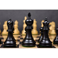 Black Executive Staunton king, queen, and bishop on a chessboard.