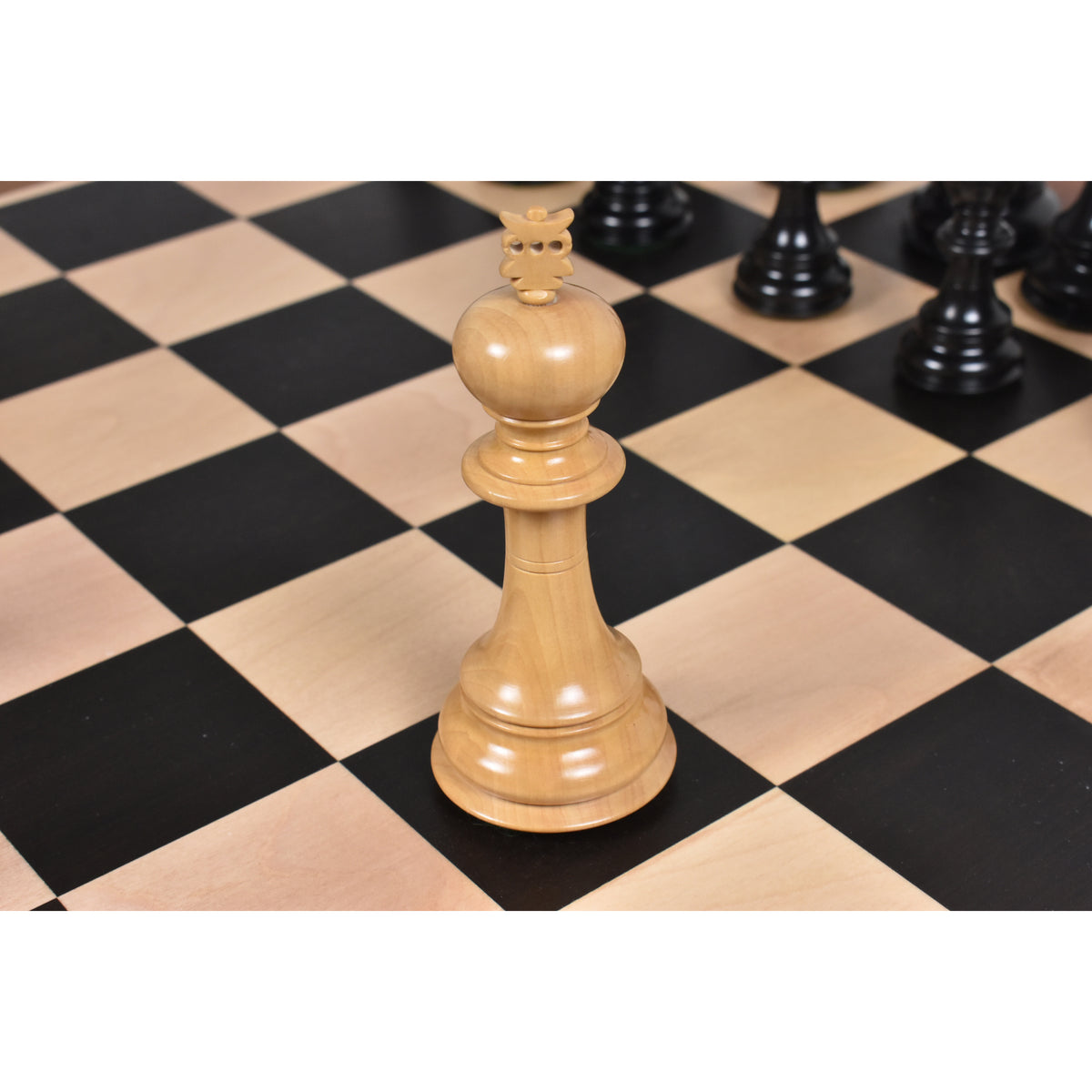 Elegant light boxwood Staunton king chess piece showcased on a premium wooden board.