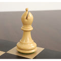 Natural boxwood Staunton bishop with detailed miter cut and weighted base on a checkered board.