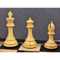 Boxwood king, queen, and bishop of the Alban Staunton design displayed on a polished chessboard.