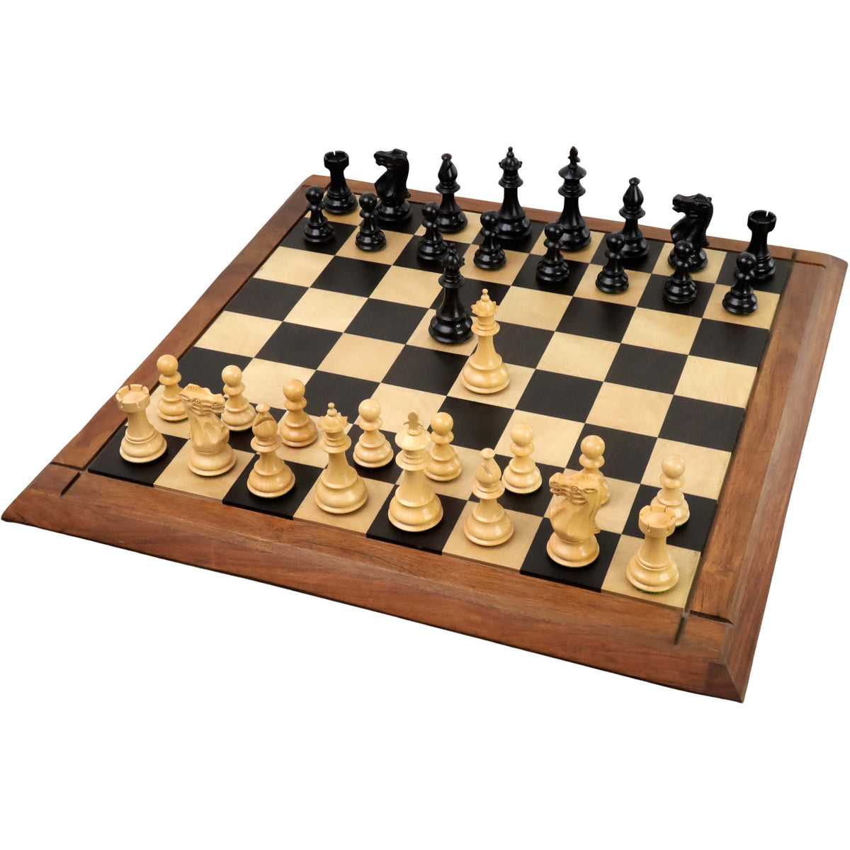 3.7" British Staunton ebonised boxwood chess pieces arranged on a wooden board with opposing queens in the center.