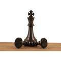 Antique brass metal luxury chess piece King upright with fallen pawns showcasing the felted base details.