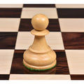 Macro view of the Rosewood Dubrovnik knight on a dark square of the chess board, highlighting the carving detail.