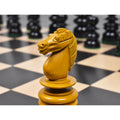Tight close-up of a carved antiqued boxwood knight from the pre-Staunton Calvert chess set.