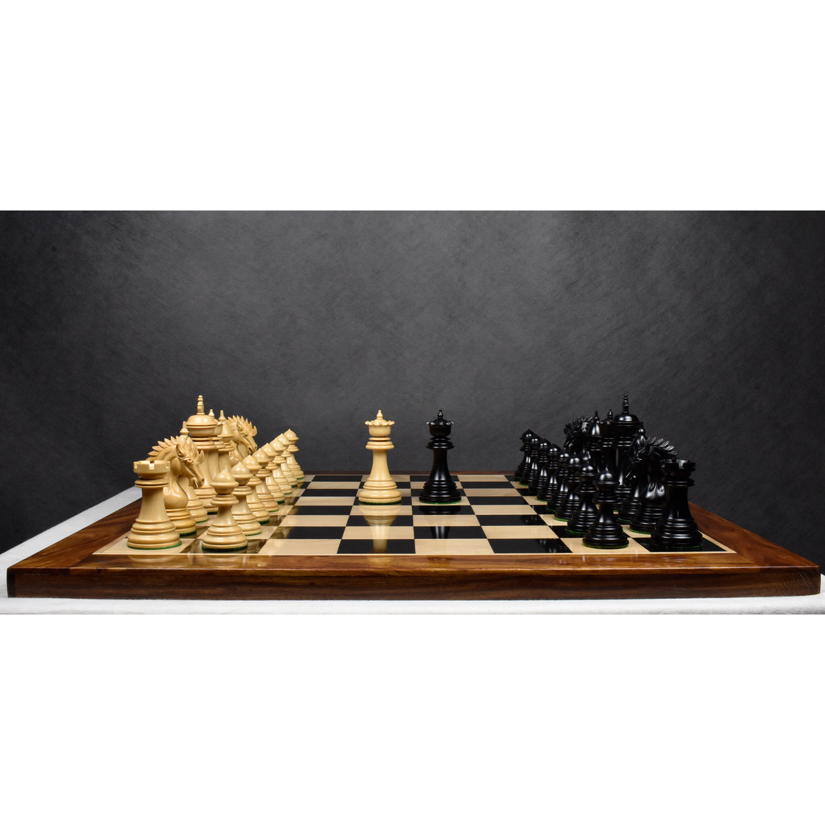 Complete Dragon Luxury Staunton chess set with opposing boxwood and ebony pieces arrayed for a game.