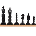 Complete lineup of six black Minaret series hand-carved camel bone chess pieces on a wooden ledge.