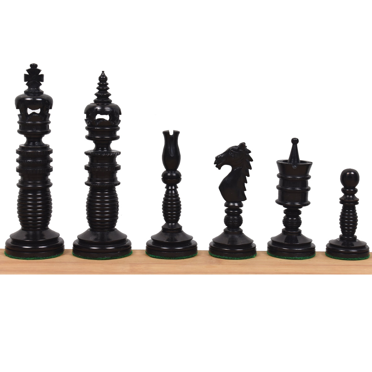 Complete lineup of six black Minaret series hand-carved camel bone chess pieces on a wooden ledge.