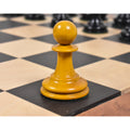 Antiqued boxwood Harrwitz Staunton pawn resting on a wooden chess board.