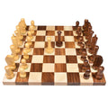 Front eye-level view of the complete Berliner modern minimalist chess pieces on a wooden board.