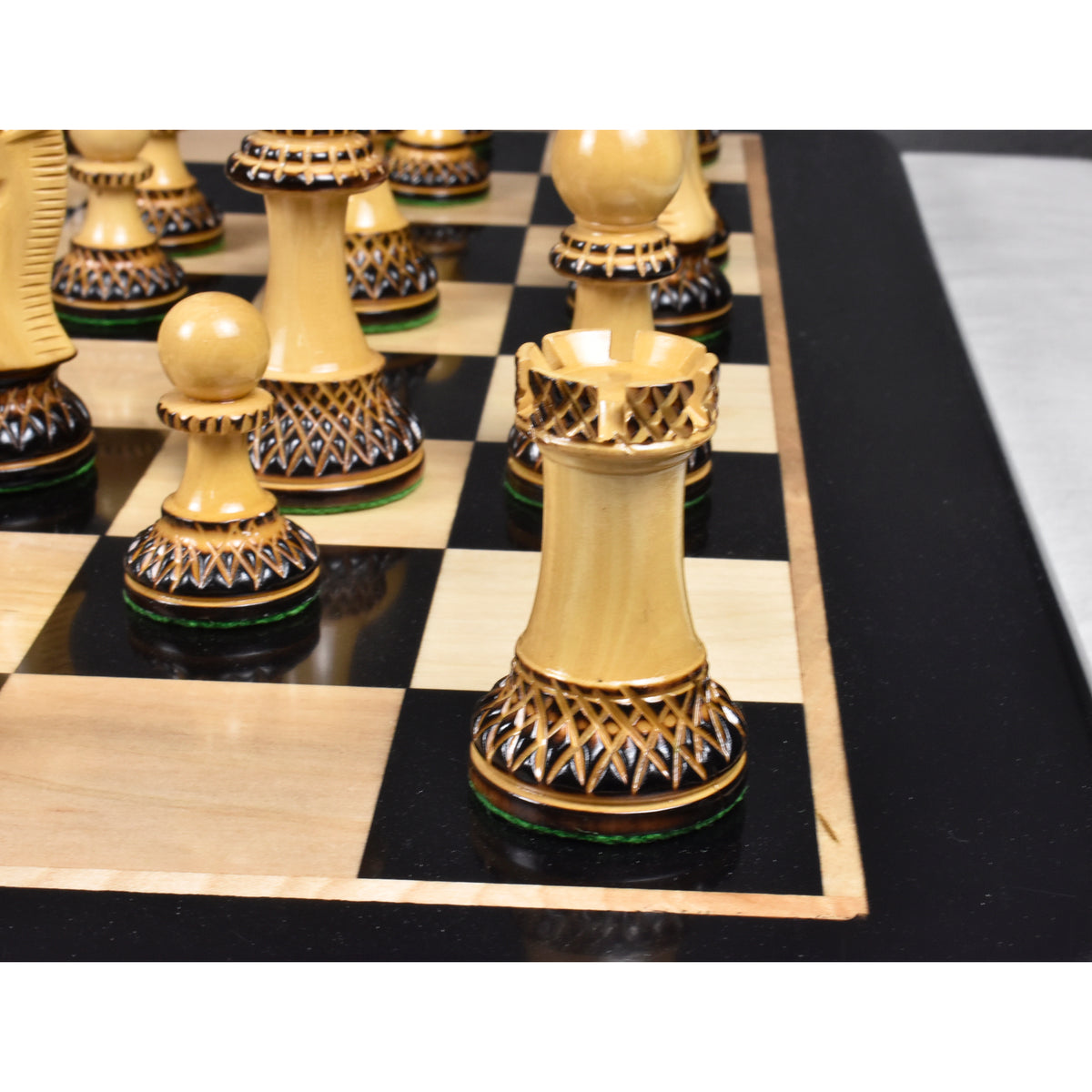 Parker Staunton lacquer gloss finish boxwood chess pieces aligned on a premium board.