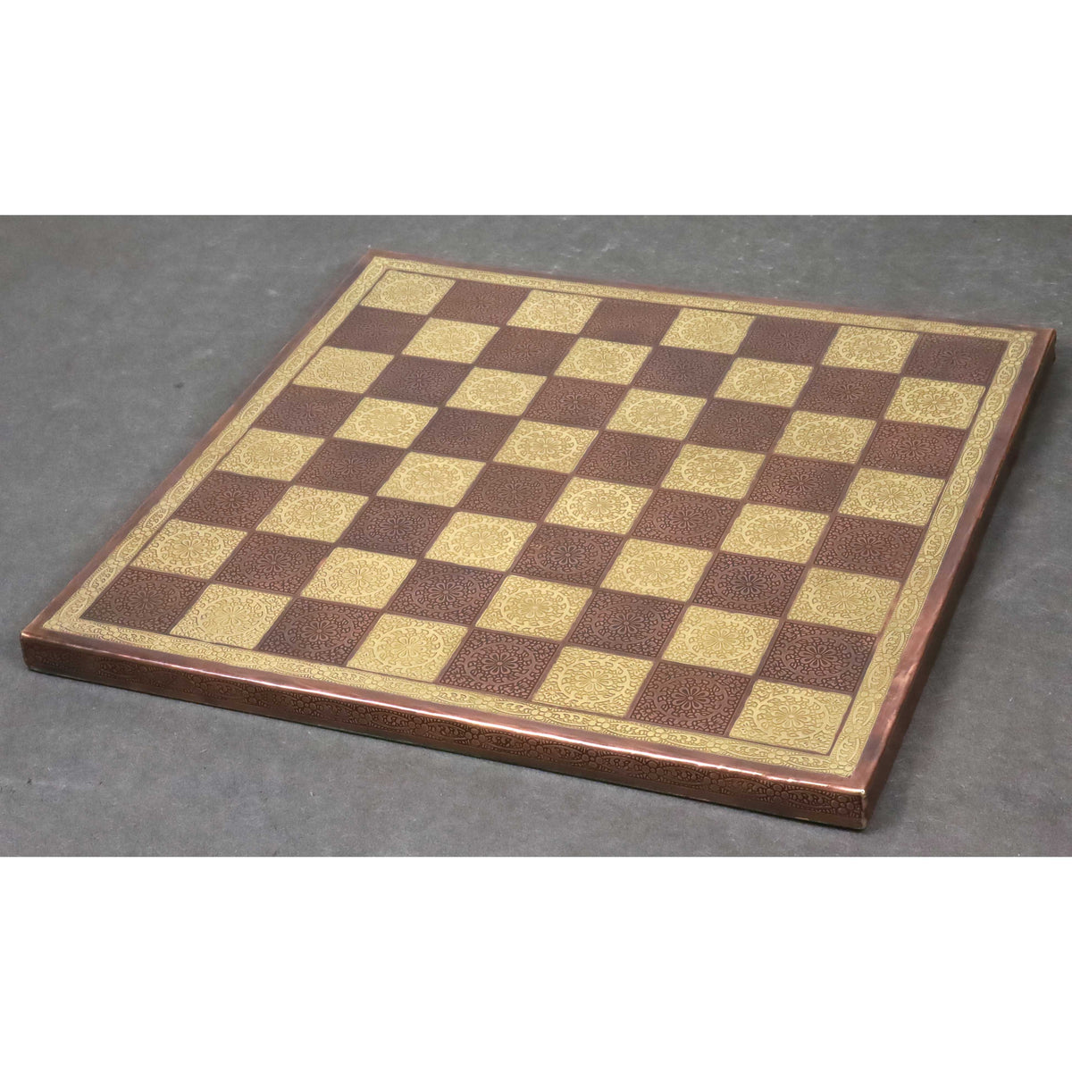 A 14 inch luxury brass metal chessboard featuring intricate floral engravings in gold and copper tones.