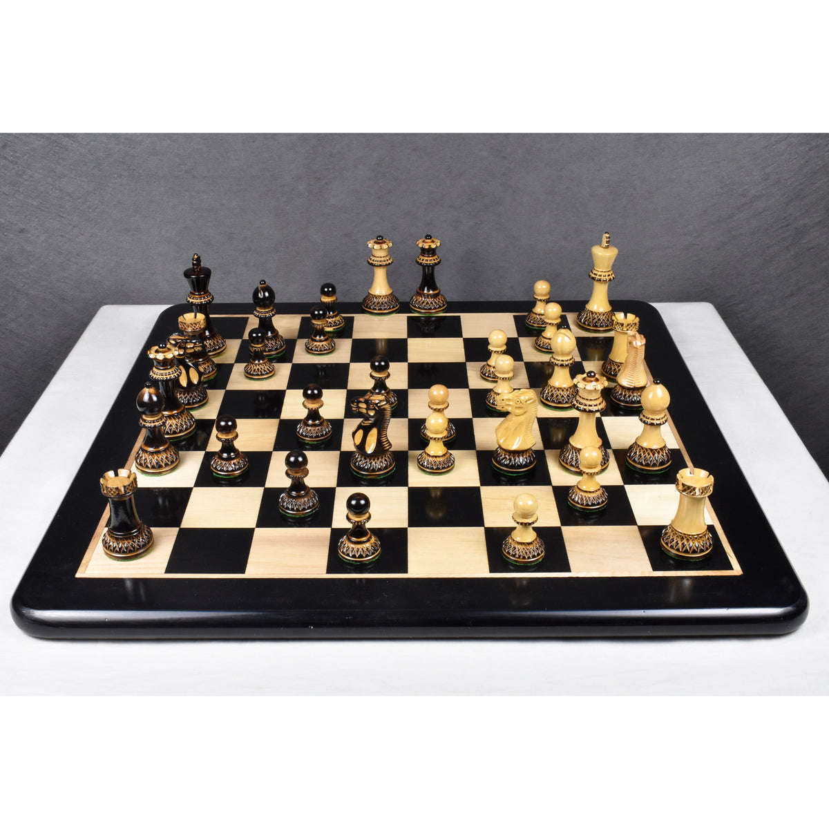 High-angle shot of the 3.9 inch Parker Staunton lacquer finish chess pieces on a board.