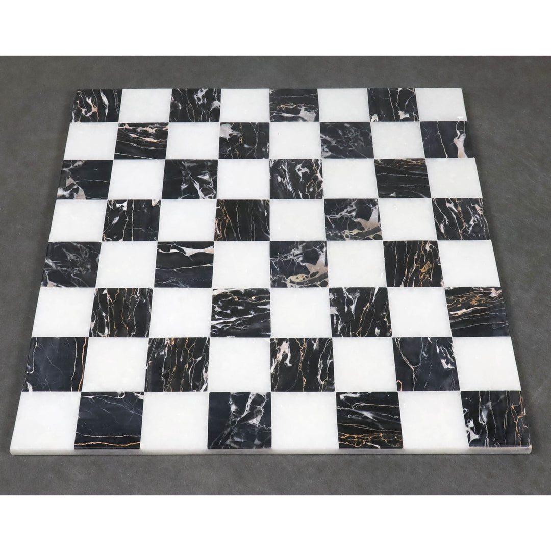 Symmetric top-down layout of a borderless black and white marble stone chess board.