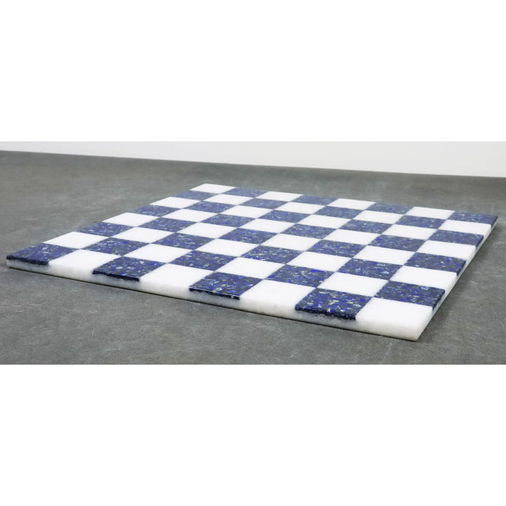 Low profile view of a 15 inch borderless marble chess board with blue and white squares.