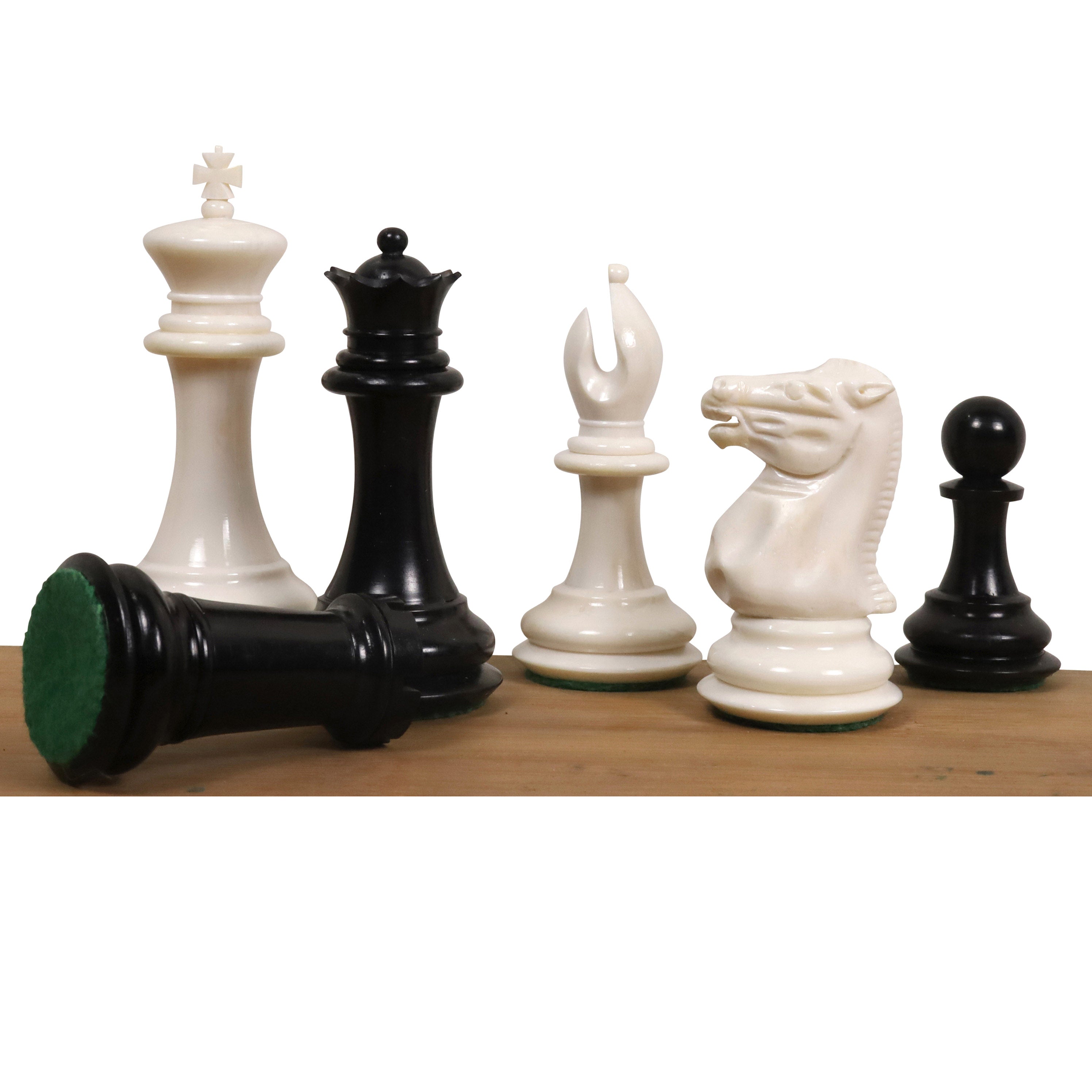 Hand-carved white and black camel bone chess pieces in a Jacques Cook 1849 Staunton style.