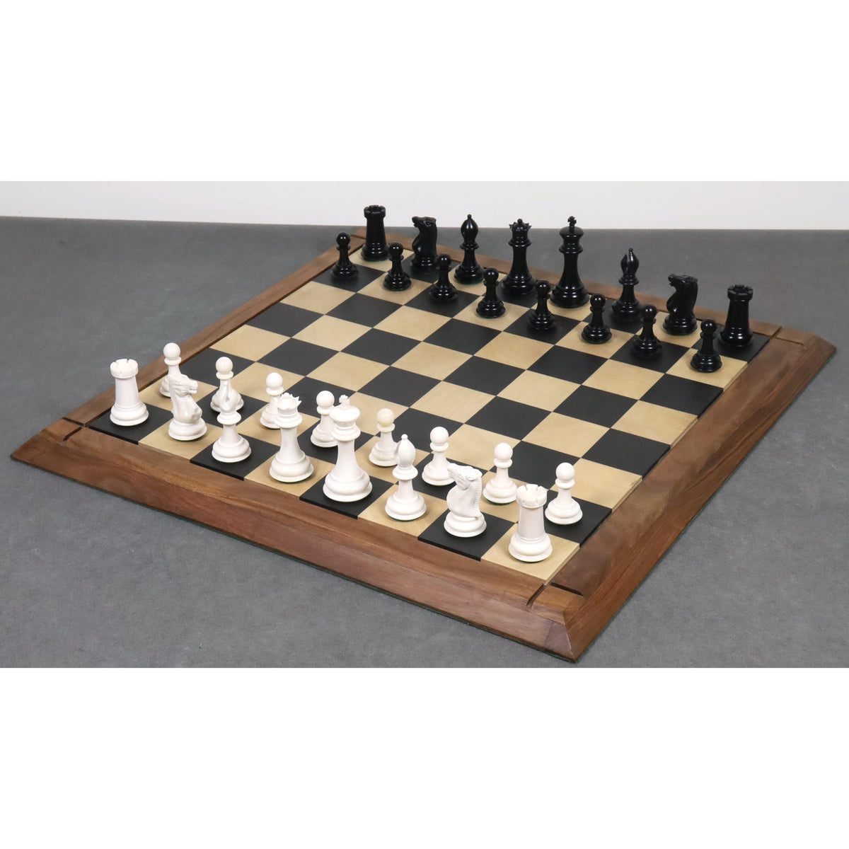 Complete 1849 Jacques Cook camel bone chess set displayed on a premium maple and ebony wooden board.