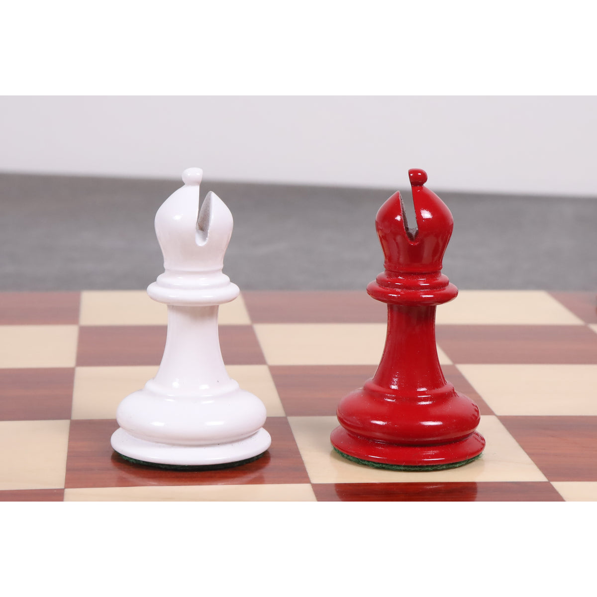 Red and white bishops from the 1849 Jacques Cook Staunton set with classic deep mitre cuts.