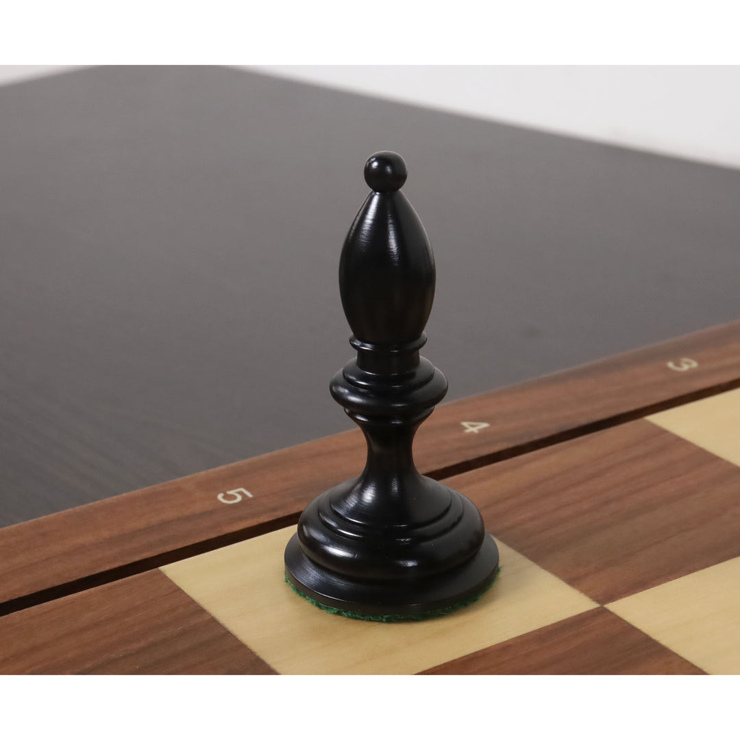 Ebonised boxwood bishop from the 1933 Botvinnik Flohr-I Soviet chess set on a wooden board.