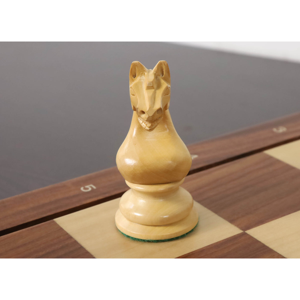 Front view of a hand-carved Boxwood Knight from the 1933 Botvinnik Flohr Soviet chess set.