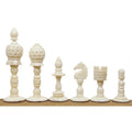Light side lineup of the 3.7" English Series Pre-Staunton camel bone chess pieces on a wooden surface.