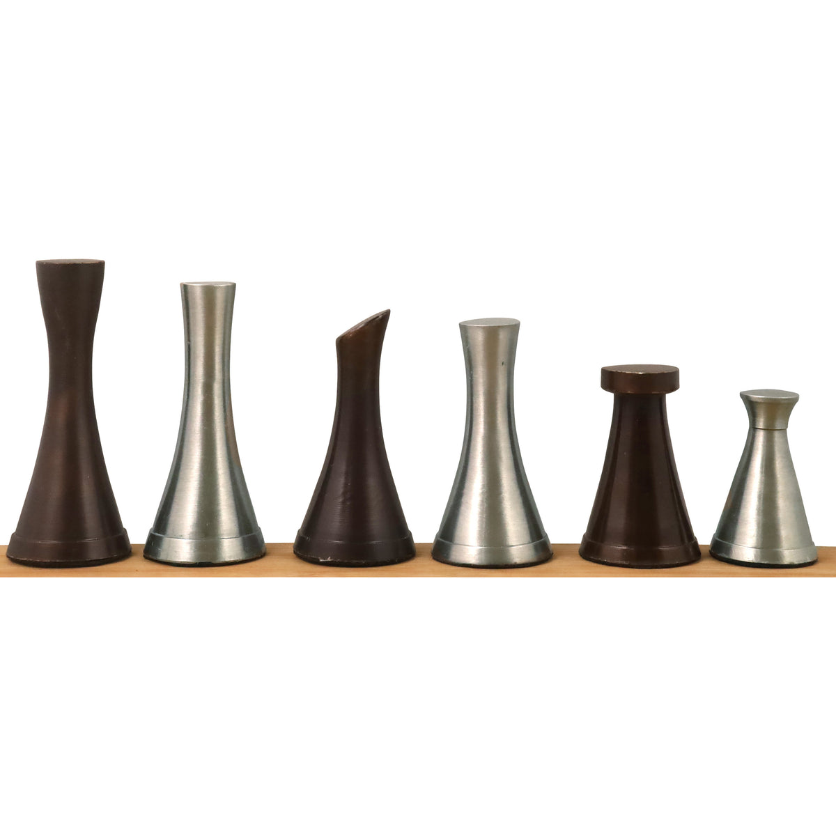 Minimalist silver and antique brass metal chess pieces in a single horizontal row.