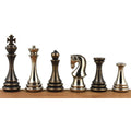 Six Russian Zagreb metal luxury chess pieces in silver and antique finish standing on a wooden bar.