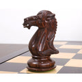 Close-up of light boxwood Staunton chess pieces including knight and rook.