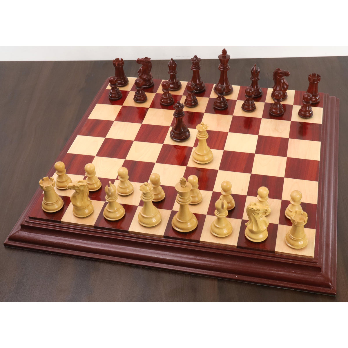 Full layout of the weighted bud rosewood and boxwood chess set arranged on a matching luxury wooden board.