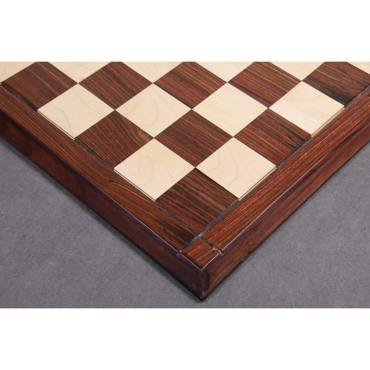 Detailed shot of the wood grain and border construction of the Players Choice Rosewood and Maple wood chess board.