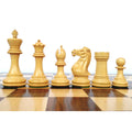 White Staunton chess pieces lined up on a wooden chessboard.