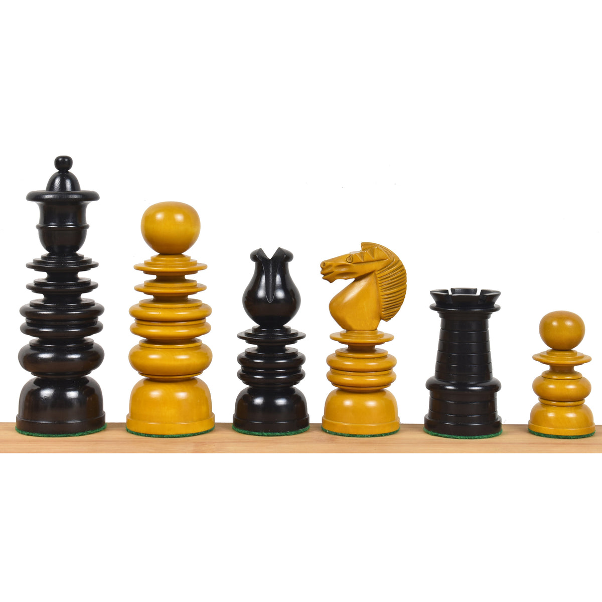 Antiqued boxwood and ebony St. George Calvert chess pieces lined up by height.