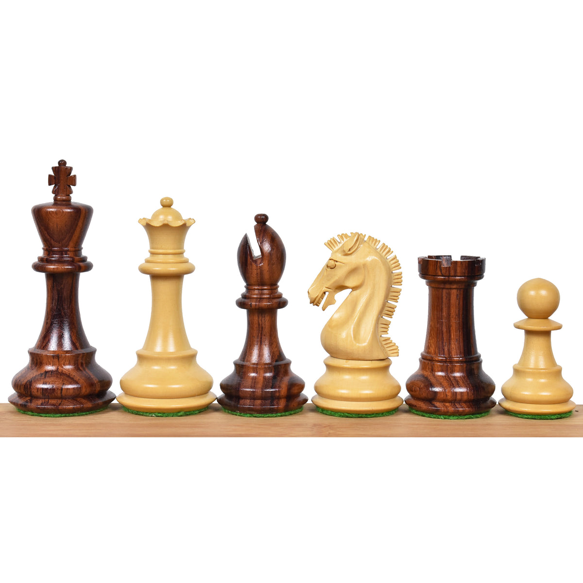 Mixed lineup of dark rosewood and light boxwood 3.9" Craftsman Staunton chess pieces on a wooden surface.