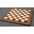 Full perspective view of a 21" raised luxury wood chess board with 55mm squares on a grey surface.