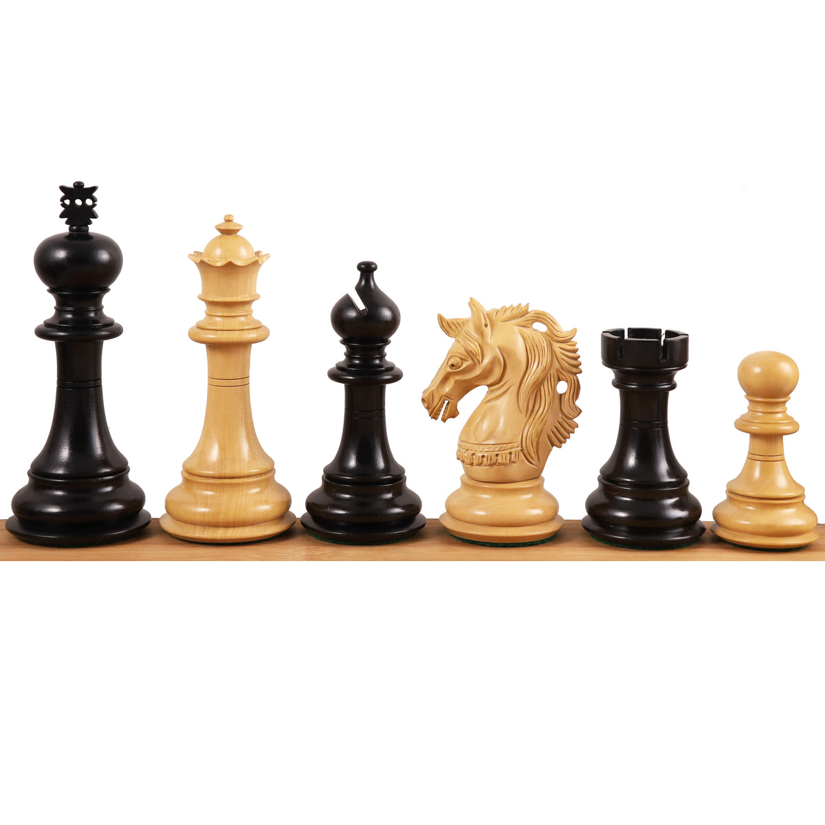 Six handcrafted boxwood chess pieces from the Prestige Luxury Staunton collection lined up against a white background.
