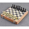 Complete handcarved soapstone chess set with pieces arranged on a 10-inch storage board.