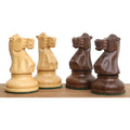 Four carved Staunton knights, two light boxwood and two dark golden rosewood, facing each other.