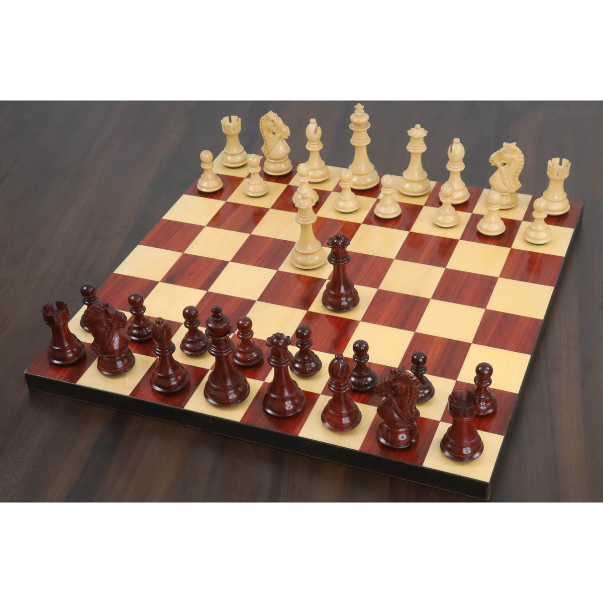 3.9 inch Bridle Staunton luxury chess pieces arranged on a polished wood board in an angled overview.