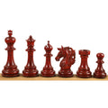 Complete set of luxury bud rosewood Staunton chess pieces lined up on a wooden surface.
