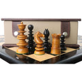 Grouping of antique and ebony Calvert chess pieces including a knight, rook, and queen in front of a box.