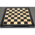 Top view of a 21 inch Ebony and Maple solid wood chess board with 55mm squares on a dark wooden table.