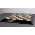 Close-up of a premium ebony and maple chess board surface.