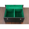 Open black storage box with two internal compartments lined in green felt for chess pieces.