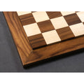 High-angle detail of the raised playing surface and mitered border of a handcrafted Rosewood chess board.