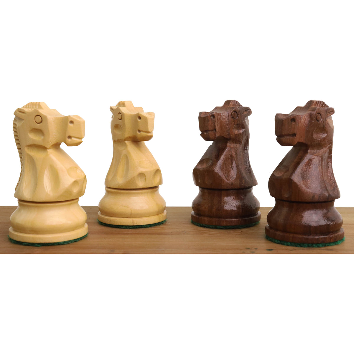 Side-by-side boxwood and golden rosewood knights from the Reykjavik Series Staunton chess set.